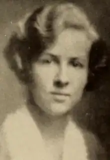 A soft-focus sepia-toned photo of a young white woman with blonde hair