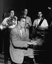 Lawrence at the piano with three band members, 1946