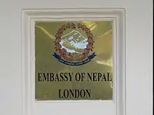 Plaque outside the embassy depicting the Emblem of Nepal