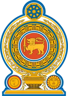 Coat of arms of Sri Lanka, showing a lion holding a sword in its right forepaw surrounded by a ring made from blue lotus petals which is placed on top of a grain vase sprouting rice grains to encircle it. A Dharmacakra is on the top while a sun and moon are at the bottom on each side of the vase.