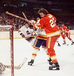 Atlanta player Eric Vail and an unknown Colorado player press against each other as they battle for position in front of the Colorado net.