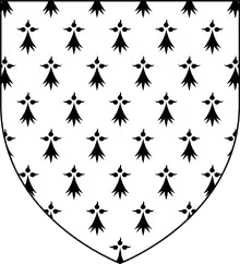 A shield shape. Inside the shield is a white background with black ermine symbols.