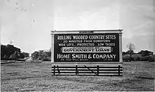 Large sign in the middle of a farmer's announcing Kingsway development