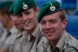 Brass and silver cap badges of Royal Marines junior officers.