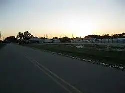 There are semi-truck-sized bales of cotton stored on this lot along Fairchilds Road.