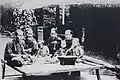 A family in Saigon eating together on top of a sập.