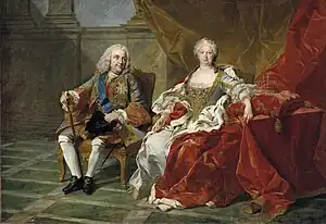 Royal couple seated in a sumptous marble hall on thrones, the queen in a bejeweled white silk dress with her arms on a red pillow holding a crown. The king, in a silvery-blue military coat, is looking towards his wife.