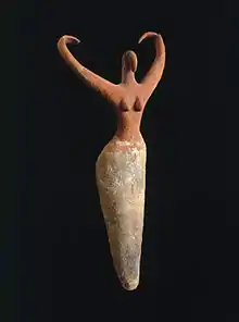 Image 3Naqada figure of a woman interpreted to represent the goddess Bat with her inward curving horns. Another hypothesis is that the raised arms symbolize wings and that the figure is an early version of the white vulture goddess Nekhbet, c. 3500–3400 B.C.E. terracotta, painted, 11+1⁄2 in × 5+1⁄2 in × 2+1⁄4 in (29.2 cm × 14.0 cm × 5.7 cm), Brooklyn Museum (from Prehistoric Egypt)