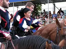 Sardinian men and children in traditional dress at the Sagra del Redentore (Nuoro)