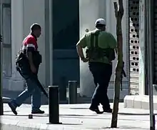 Armed Lebanese militiamen wearing locally produced Ephod Combat Vests running for cover near the Crown Plaza Hotel on the Hamra district in Beirut during the 2008 conflict in Lebanon.