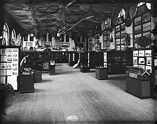 #42 (24/9/1877)Fisheries Court exhibit at the United States National Museum in Washington, D.C. (in what is now the Arts and Industries Building), as it appeared in 1886. J. H. Emerton's giant squid and giant octopus models are suspended from the ceiling surrounded by fishing nets (see also engraving of same).