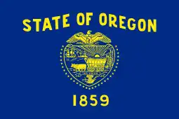 A navy blue flag with gold lettering and symbols; "STATE OF OREGON" is written above a shield, which is surrounded by 33 stars. "1859" appears underneath the shield.