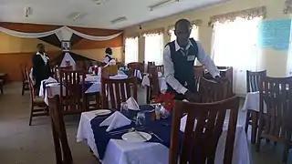 Food and Beverage students setting tables in their training restaurant