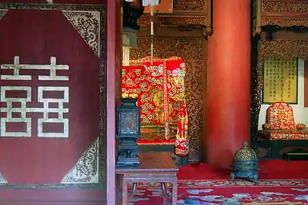 Palace of Earthly Tranquility (坤宁宫) of the Forbidden City, with traditional Chinese wedding decorations and a double happiness character in the foreground