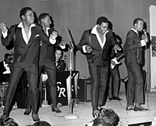 The Four Tops mid-performance at a concert.