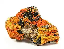 Francevillite (orange) with Curienite  (yellow) and Chervetite, Mounana Mine, Franceville, Haut-Ogooué Province, Gabon. Overall size 8.7 x 6.1 x 2.1 cm.