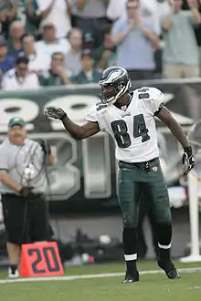 Mitchell on the field during a game pointing to signal a first down.