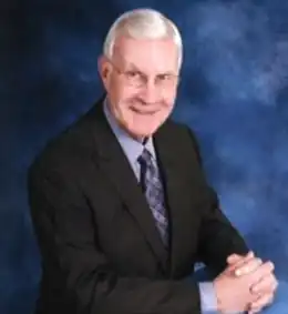 Frederick Swann portrait, in a dark blue business suit