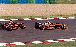 Heinz-Harald Frentzen and Enrique Bernoldi in the Orange liveried Arrows A23s at the 2002 French Grand Prix.