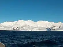 Friesland Ridge from Bransfield Strait, with St. Methodius Peak, St. Cyril Peak, Simeon Peak, St. Boris Peak, Mount Friesland and Lyaskovets Peak in the background, and Needle Peak, Macy Glacier and Peshev Ridge in the foreground