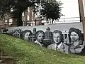 A mural depicting Greensboro College's history next to Proctor Hall.