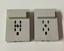 A photograph of a plastic GTN-6 socket (with seven holes) and GTN-4 socket (with five holes) side-by-side.