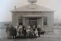 An early photo of the students and the schoolhouse, c. 1910.