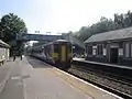 A Northern Rail Class 156 waits at the station.