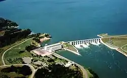 Calumet Bluff can be seen beside the Gavins Point Dam and Power Plant. The Missouri River spills through the dam below the bluff.