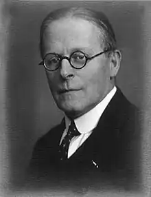 Photograph of Karo in middle age, wearing spectacles and a dark suit.