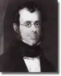 black-and-white photograph of a man in glasses