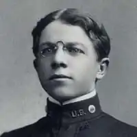 Photograph of a young man in a dark Navy uniform with "US" on his collar.