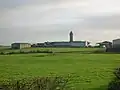 Distant view of the tower and farm buildings