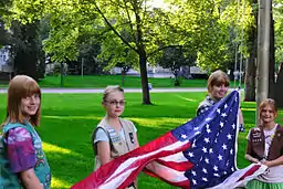 Girl Scouts raising the flag