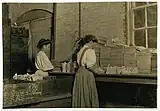 two women wrapping and boxing glasses