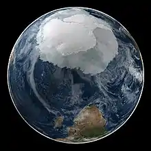 Image 86A composite image of Earth, with its different types of surface discernible: Earth's surface dominating Ocean (blue), Africa with lush (green) to dry (brown) land and Earth's polar ice in the form of Antarctic sea ice (grey) covering the Antarctic or Southern Ocean and the Antarctic ice sheet (white) covering Antarctica. (from Earth)