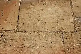 Graffito of a ship with fleur-de-lis on the sails