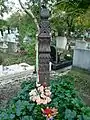 Grave of György Ugray (1908–1971) Hungarian sculptor, in the Óbuda cemetery (21/1). The wooden headboard (kopjafa) was carved by György Ugray Jr., while the bronze medal affixed to the column was made by József Ács (1972).