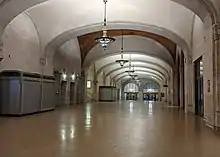 Wide interior corridor with a vaulted ceiling