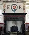 The great chamber fireplace, showing the Order of the Garter arms in the plasterwork, supported by caryatids