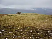 Summit cairn and remains of a Bronze Age tumulus on the summit of Great Mell Fell