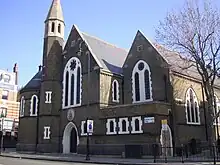 The former St Barnabas Church, Kentish Town Road, Camden in London, 1884–85 by Ewan Christian, now the Greek Orthodox Cathedral of St Andrew, showing the west front with north apse and turret