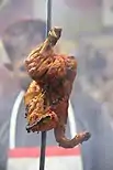 Tandoori chicken hanging at a restaurant in Agra, India.