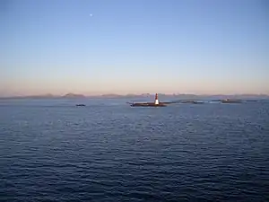 Lighthouse with fishing village in background