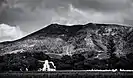 A view of the main house and surrounding hills in black and white.