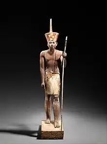 Image 88A figure wearing the red crown of Lower Egypt , most probably Amenemhat II or Senwosret II. It functioned as a divine guardian for the imiut; the divine kilt, suggests that the statuette was not merely a representation of the living ruler. (from Ancient Egypt)