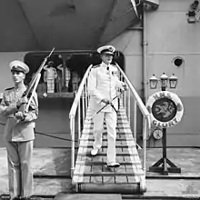 Vice Admiral Sir Guy Russell, Commander in Chief Far East Station, leaves his flagship Glory in Kure, Japan, September 1951