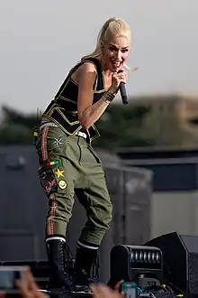 Photograph of a woman on a stage holding a microphone