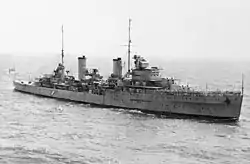 A black and white image of HMAS Sydney in open water.