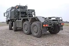 Rear three-quarter shot showing winch assembly of an HX81 8×8 HET with IAC